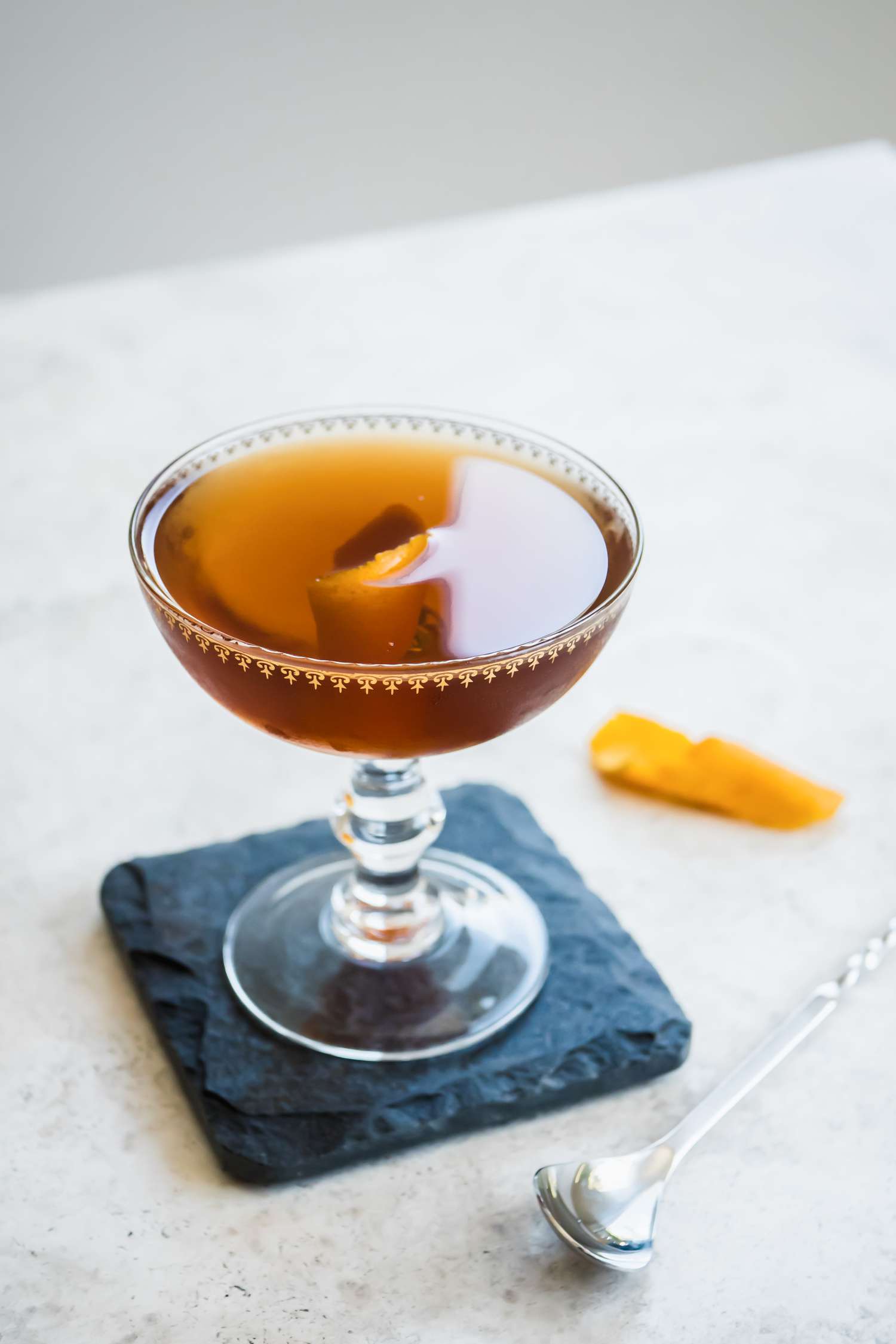 Rob Roy in Cocktail Glass on Top of Granite Coaster