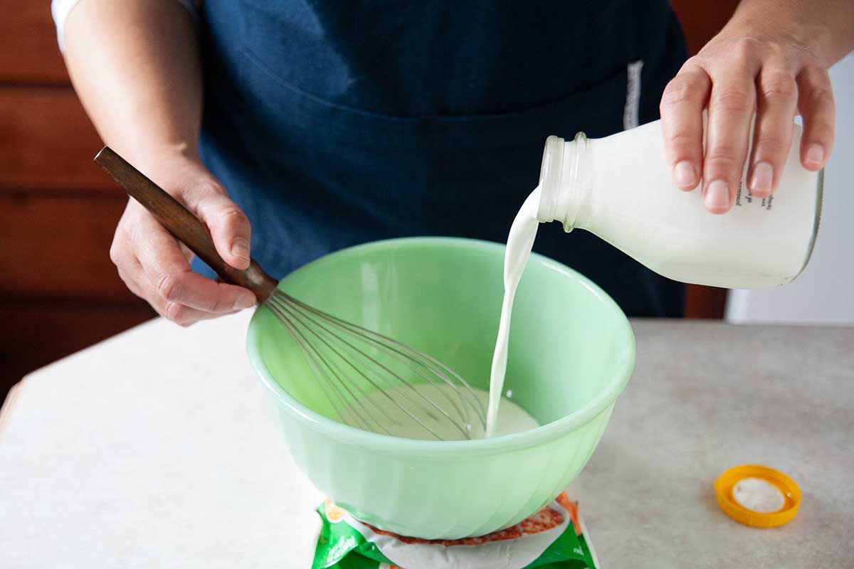How to make whipped cream by whisking heavy whipping cream into a bowl.