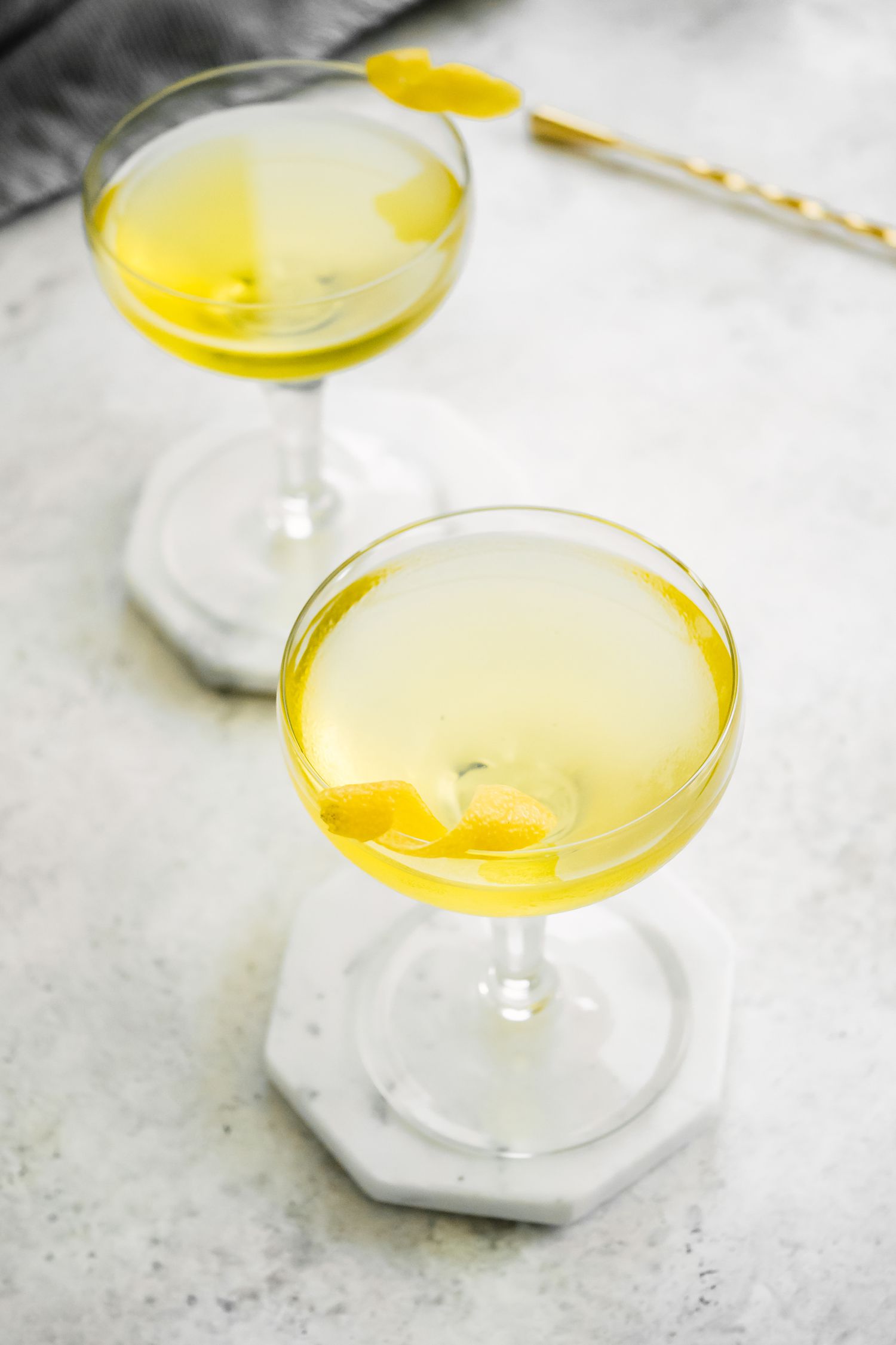 Two Glasses of White Negroni on Coasters