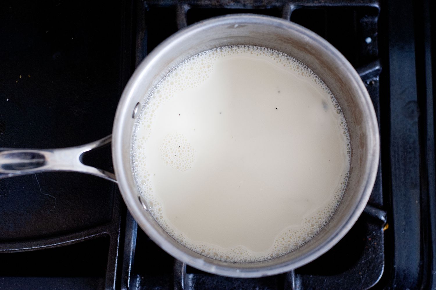 Warming the base of mint chocolate chip ice cream in a saucepan.