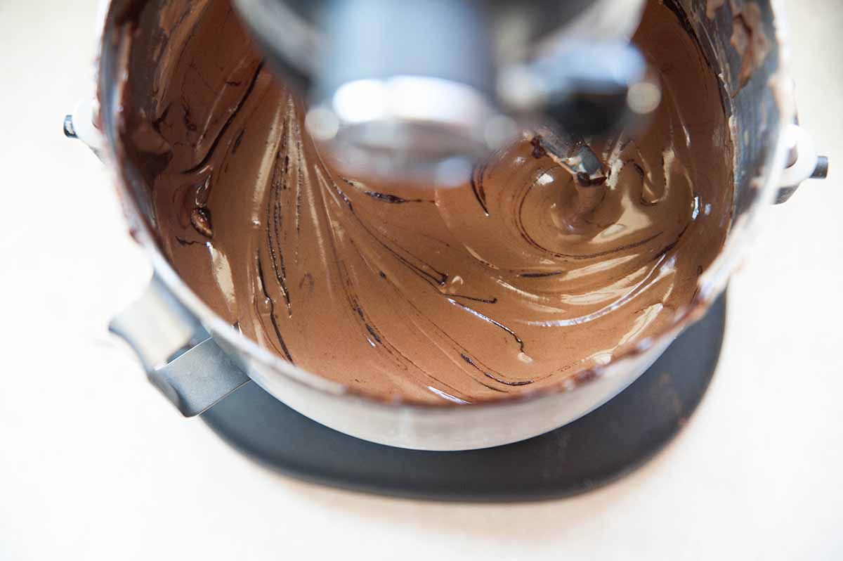 Chocolate cheesecake batter in the bowl of a stand mixer