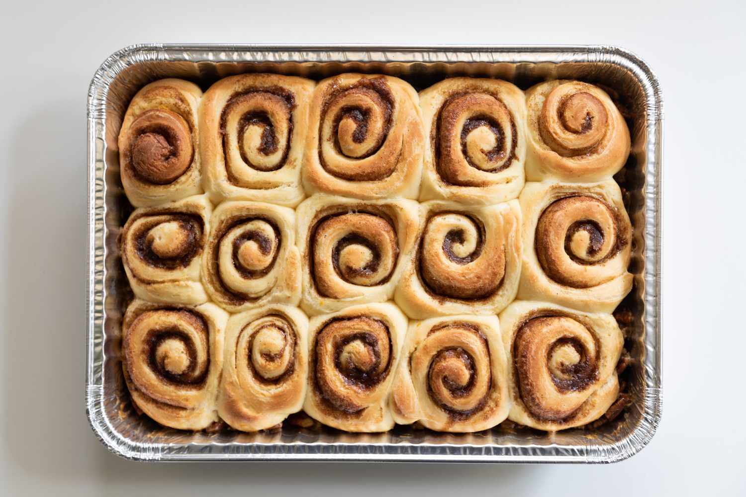 A baked pan of pecan cinnamon rolls.