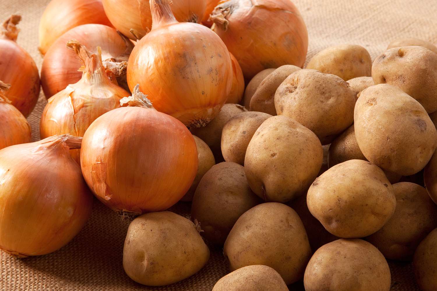 A pile of onions and potatoes