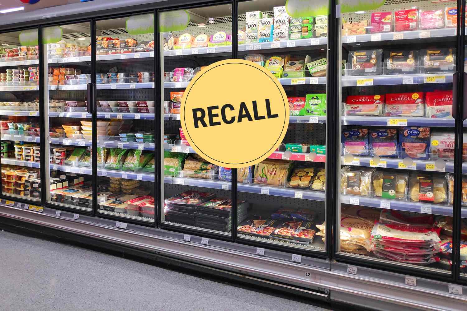 Grocery store refrigerated shelves, yellow recall sign overlay