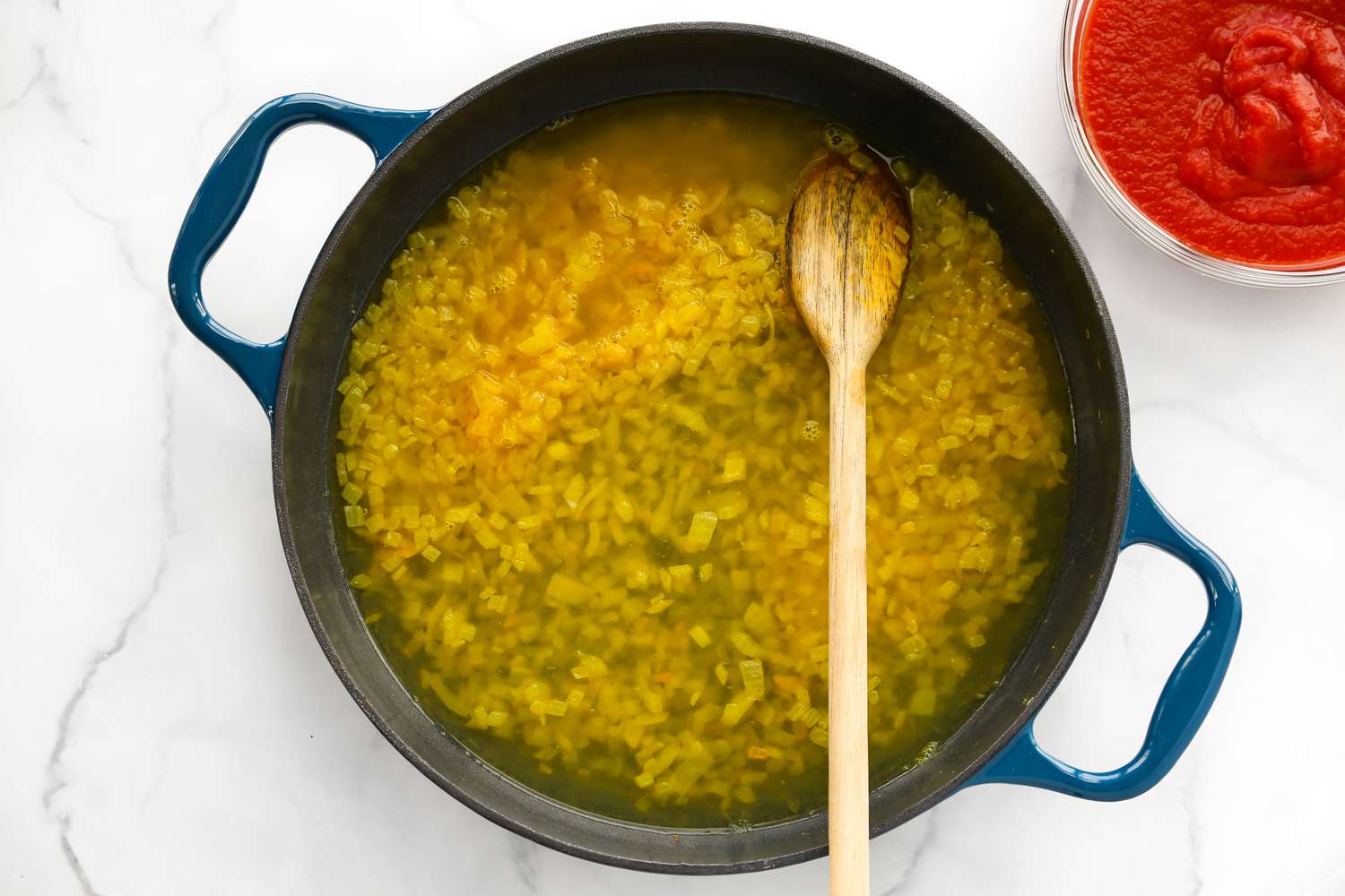 Pot of onions, turmeric, and stock