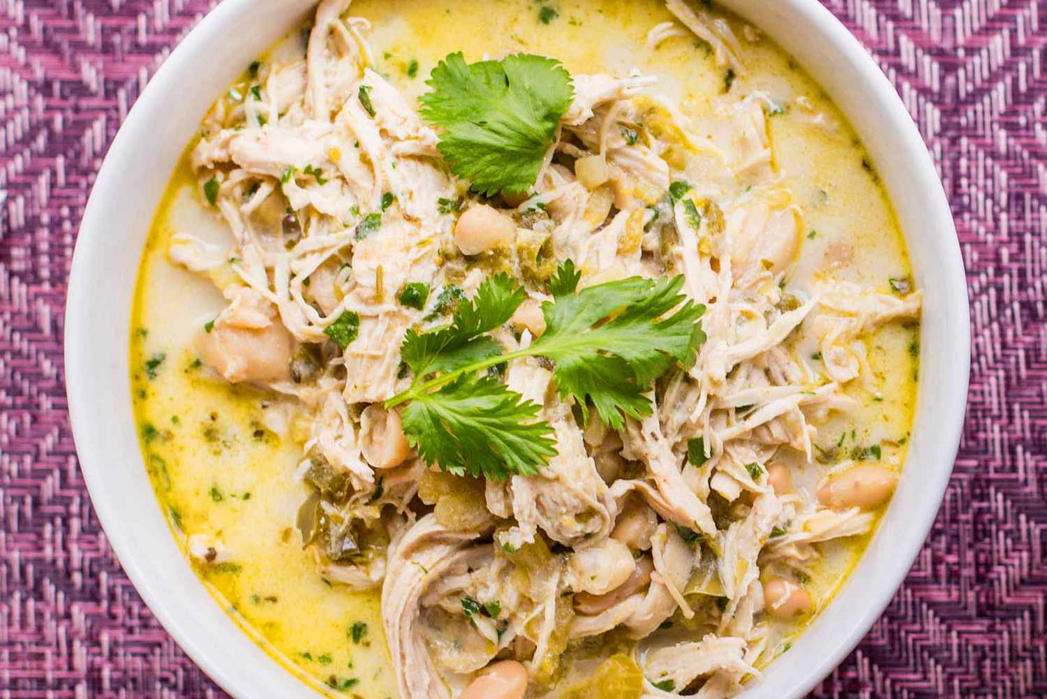 A bowl of white chicken chili topped with cilantro