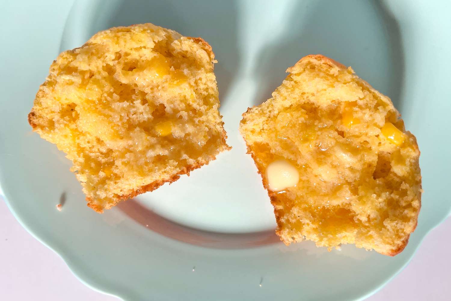 corn muffin cut in half on a plate