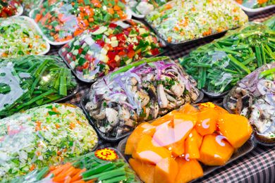 Mixed cut vegetables packed in plastic containers for sale in grocery shop