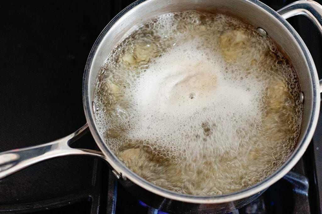Cauliflower boiling in a pot for cauliflower mash healthy shepherd's pie