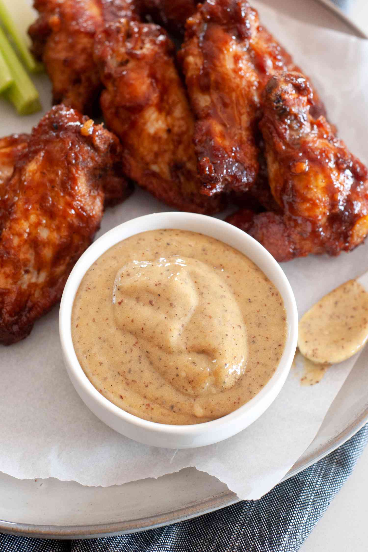 Homemade honey mustard served on a platter of chicken wings.