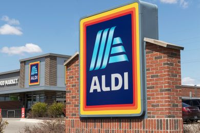 Aldi store with prominent logo sign and building in the background