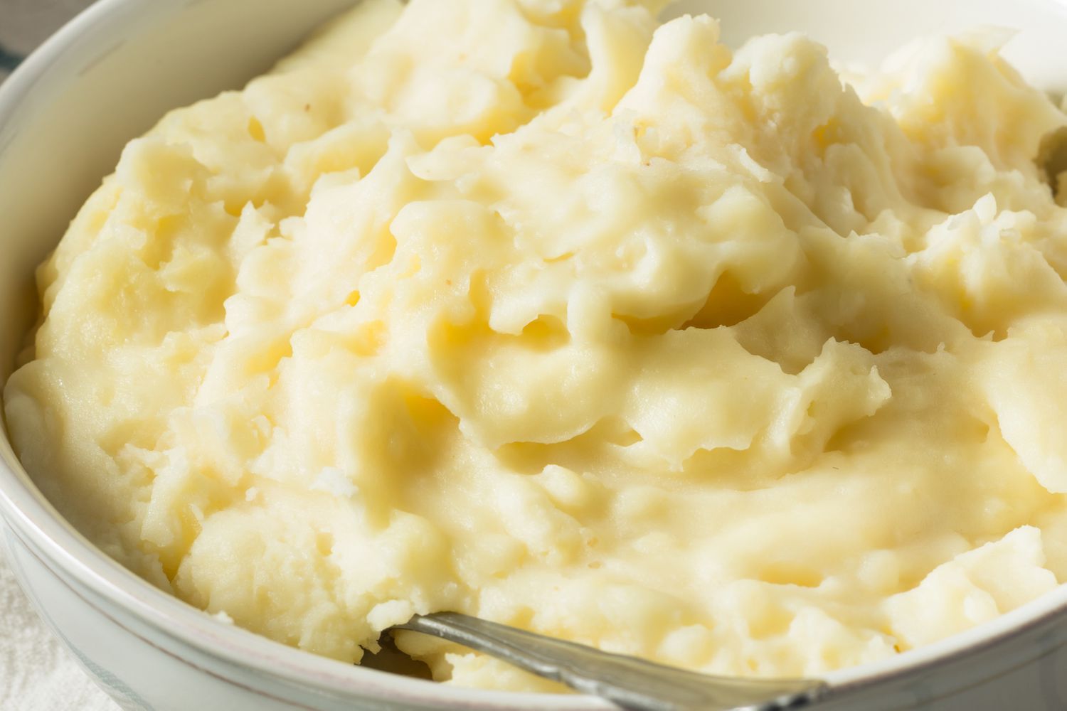 Creamy mashed potatoes in a white bowl