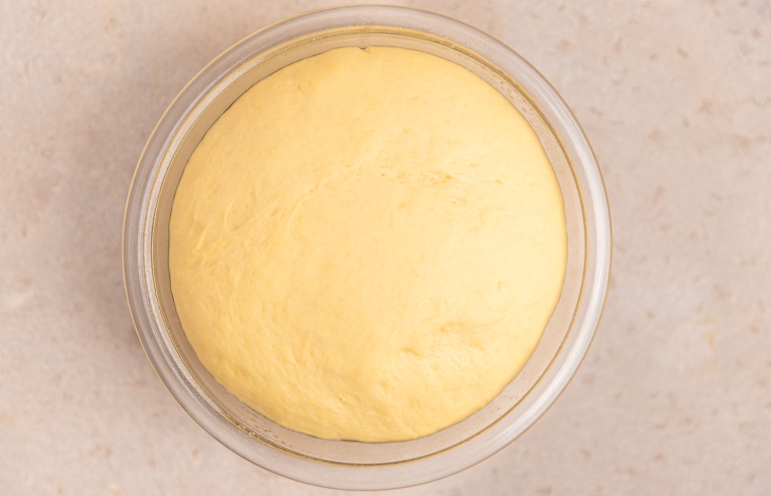 Bowl of Risen Dough for Apple Cinnamon Roll Recipe 