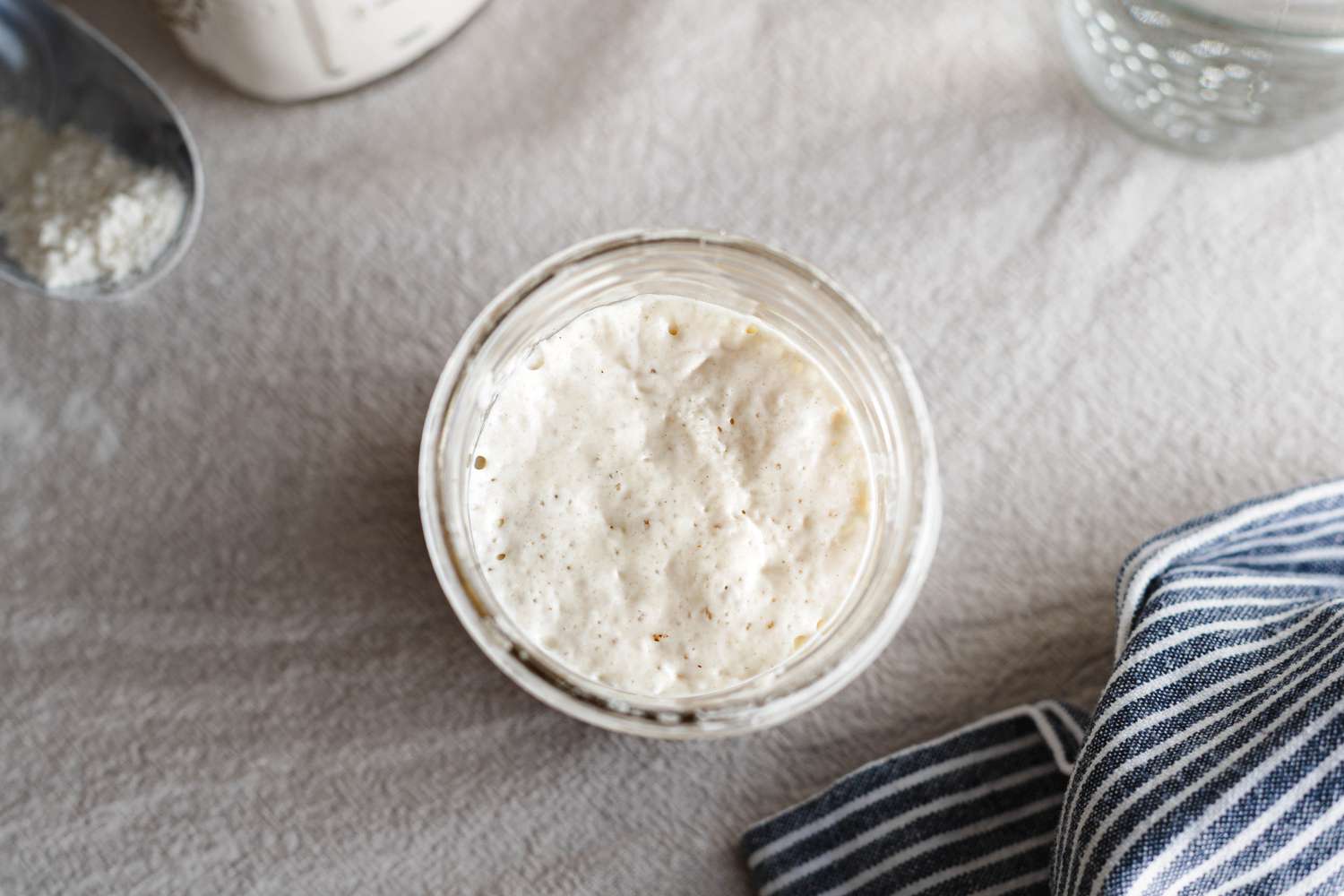 Overhead view of a simple sourdough starter in a mason jar..