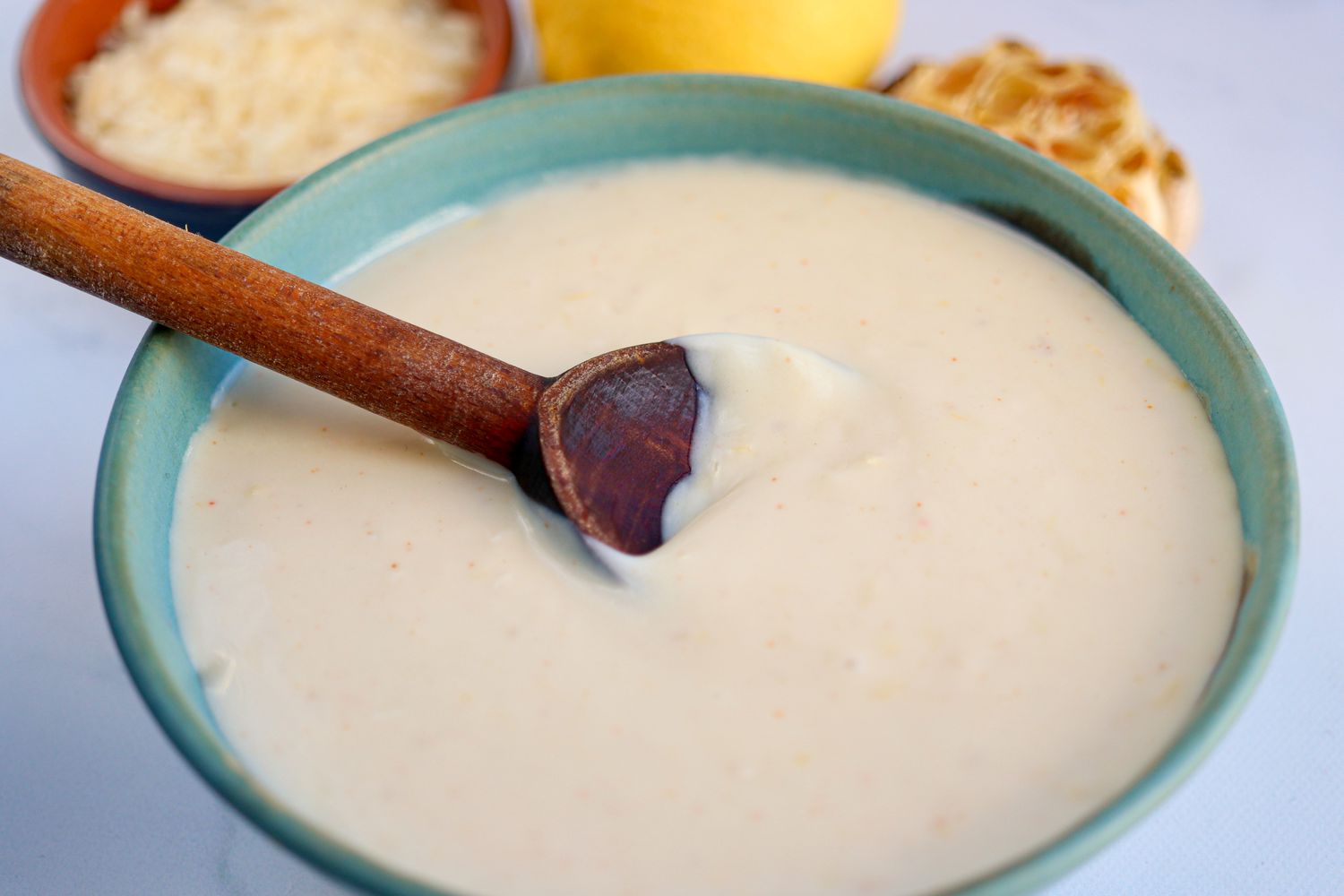 Easy Homemade Pizza Sauce in a bowl with a wooden spoon.