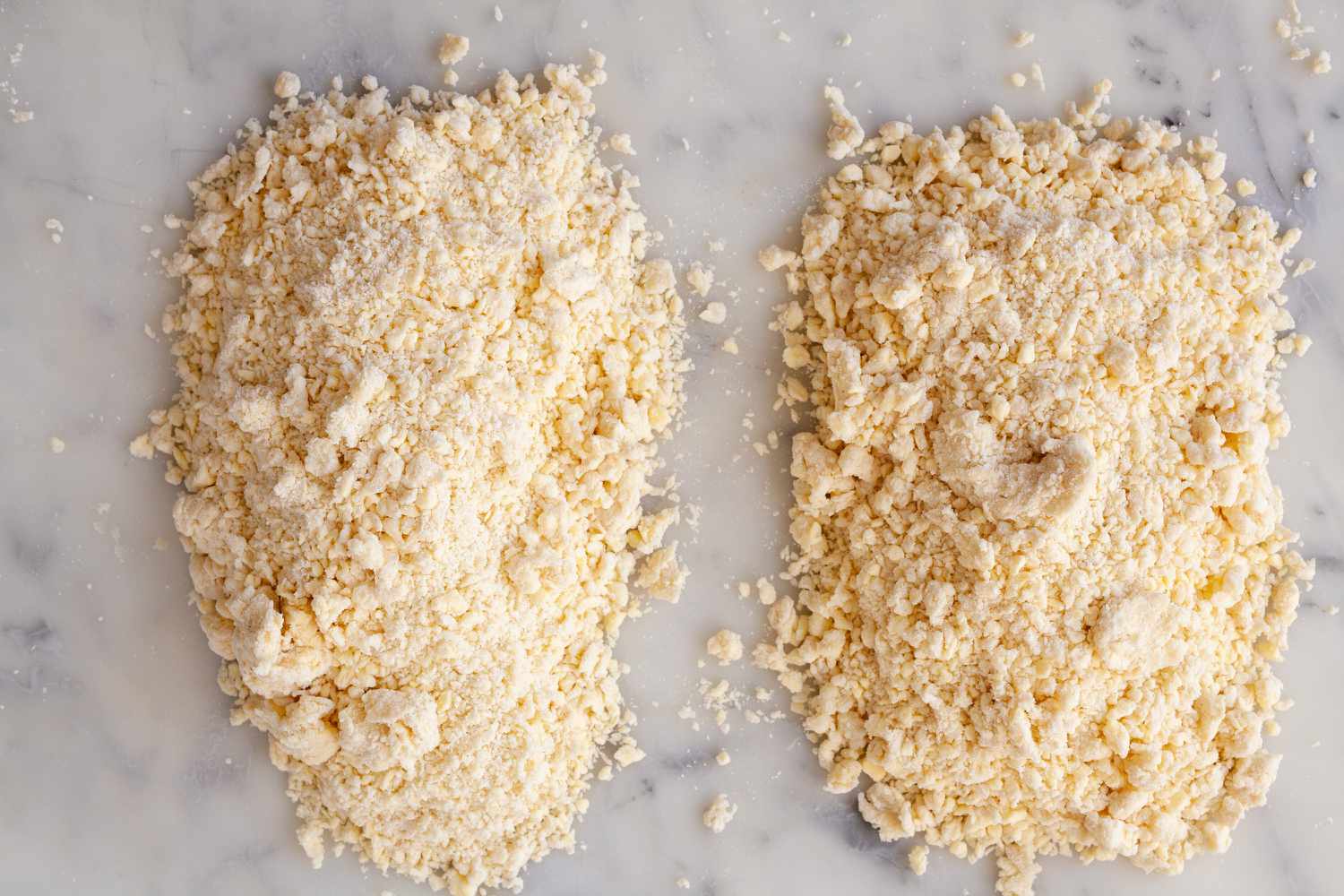 Two piles of crumbly pie dough.