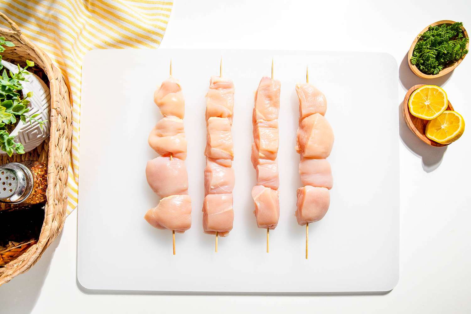 Chicken skewered on cutting board