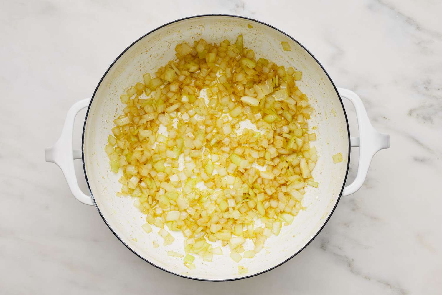 Diced onions caramelizing in a Dutch oven for hummus soup recipe