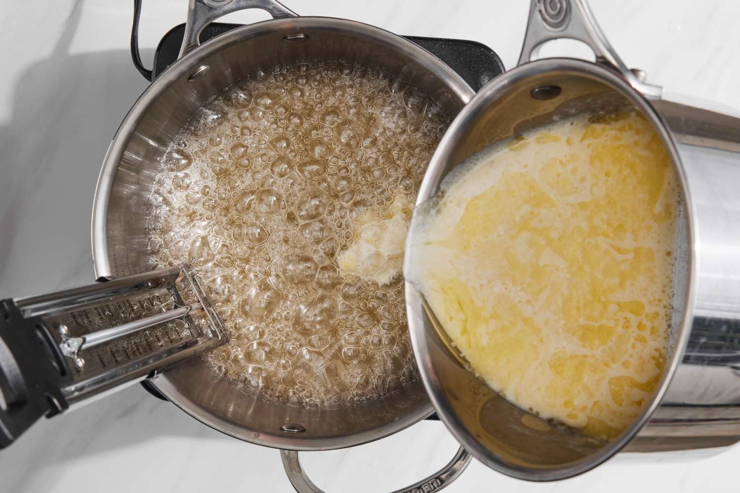 Warm Cream and Butter Mixture Added to Sauce Pan with Boiling Sugar Mixture for Holiday Candy Recipe