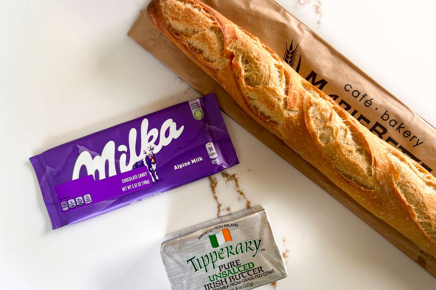 Milka chocolate, butter, and a baguette