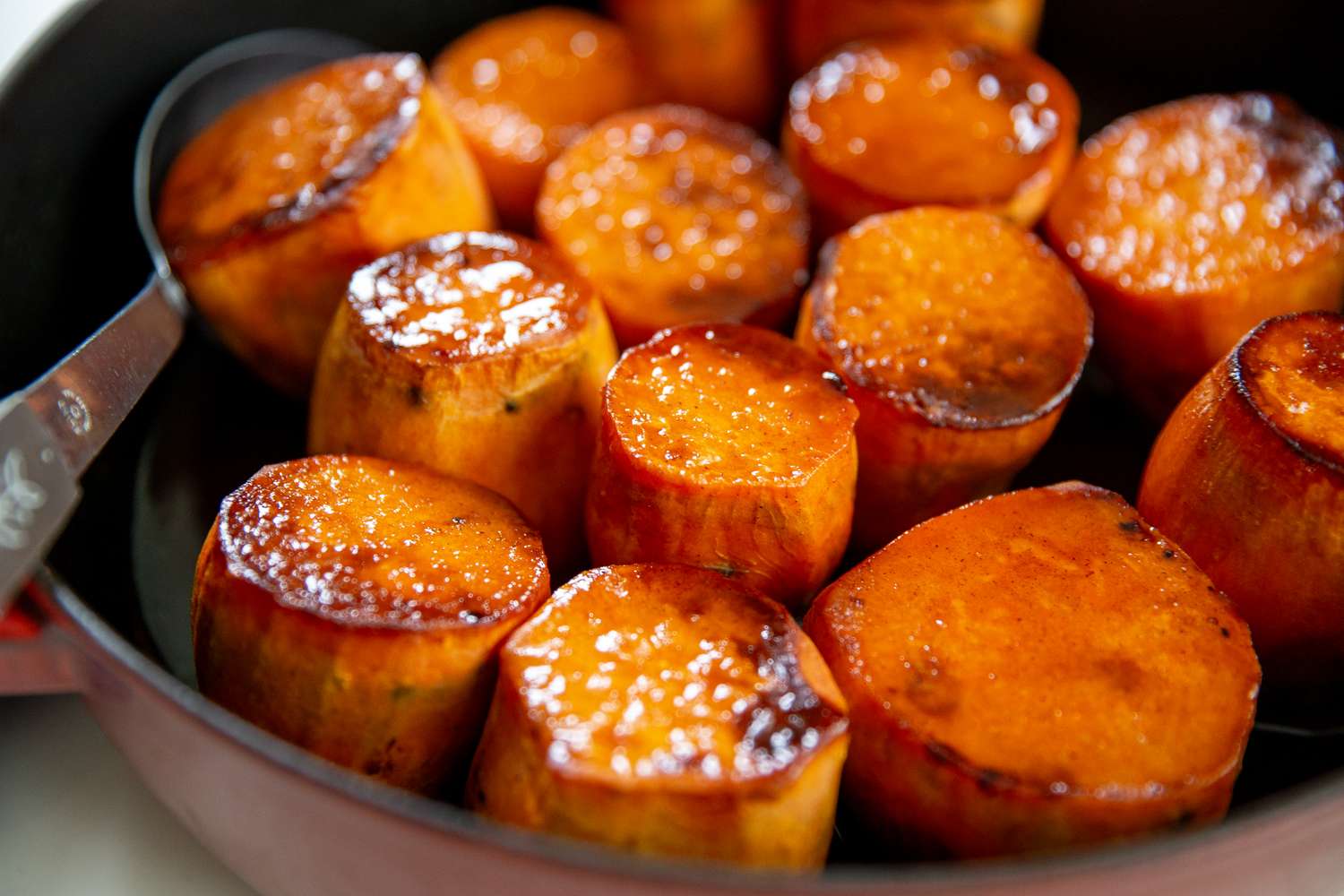 Caramelized rounds of sweet potatoes in a skillet