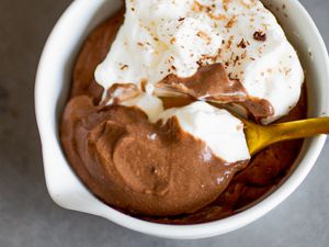 spoonful of chocolate pudding lifted from a bowl with more