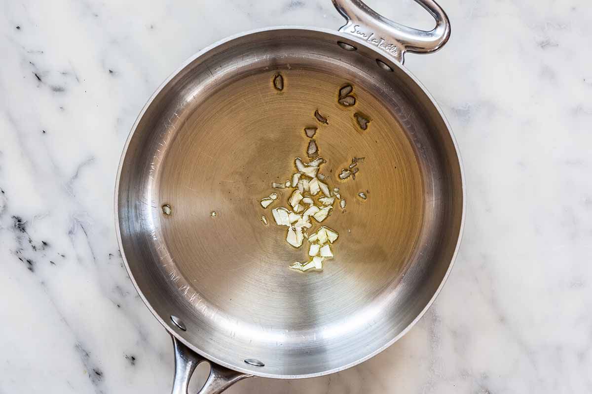 Homemade Tomato Sauce - oil and garlic in silver pan