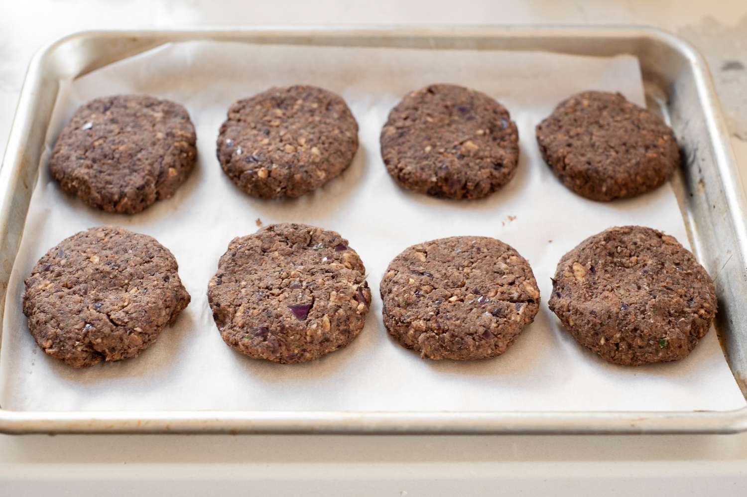 Black Bean Smash Burger Patties on a Parchment Lined Baking Pan