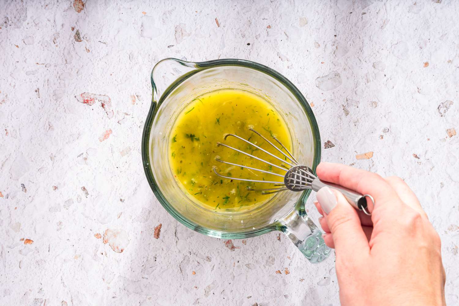 Greek Salad Dressing Whisked Together in a Pyrex Measuring Cup 