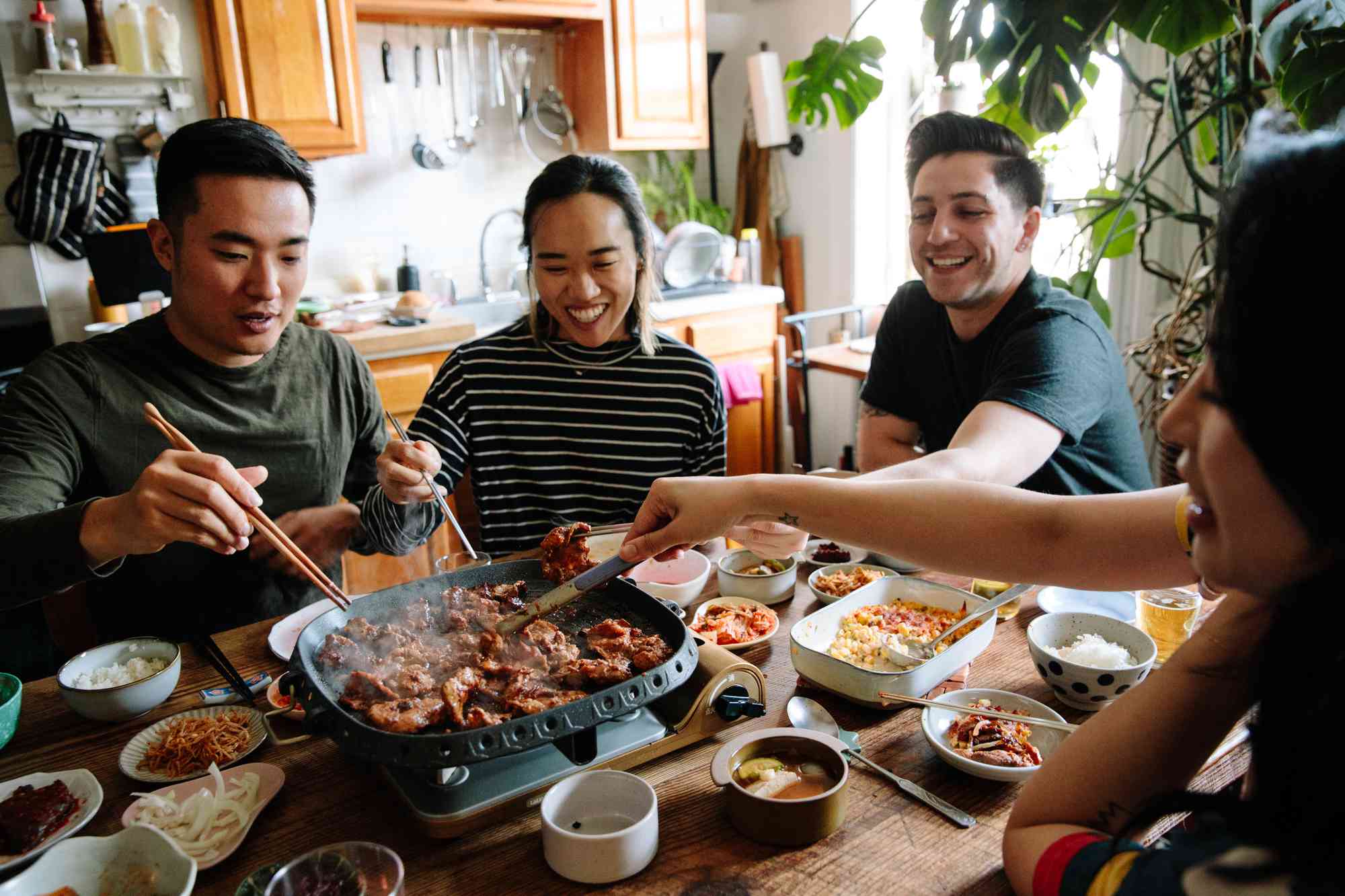 A group of friends around a table enjoying Korean BBQ