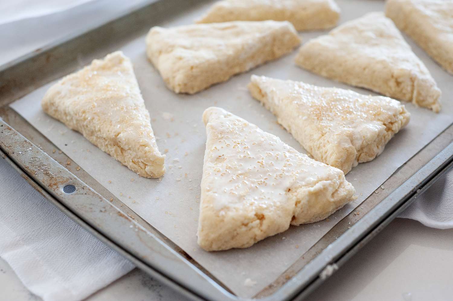 Unbaked scones on a baking sheet.