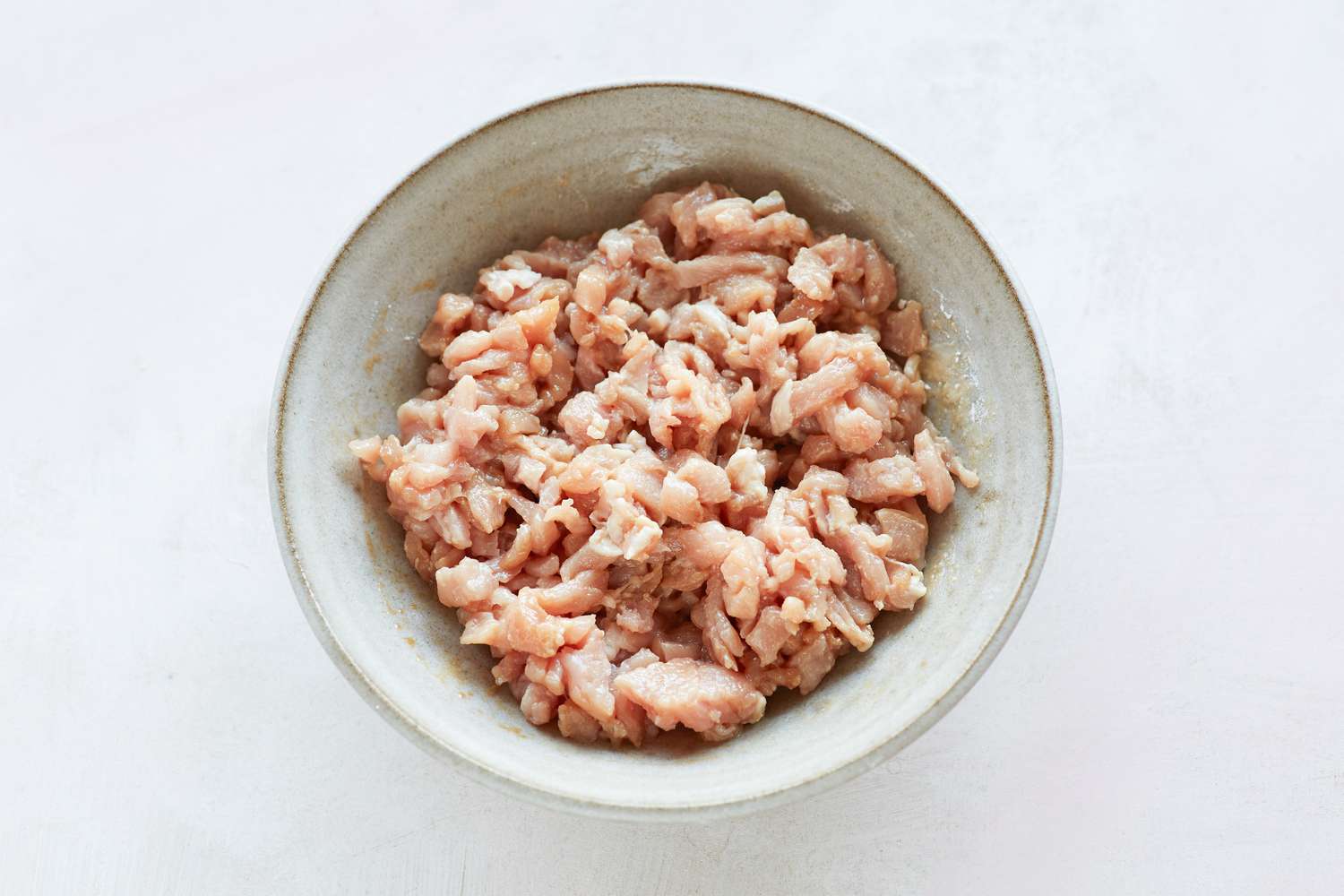 Pork filling for spring rolls in a bowl.