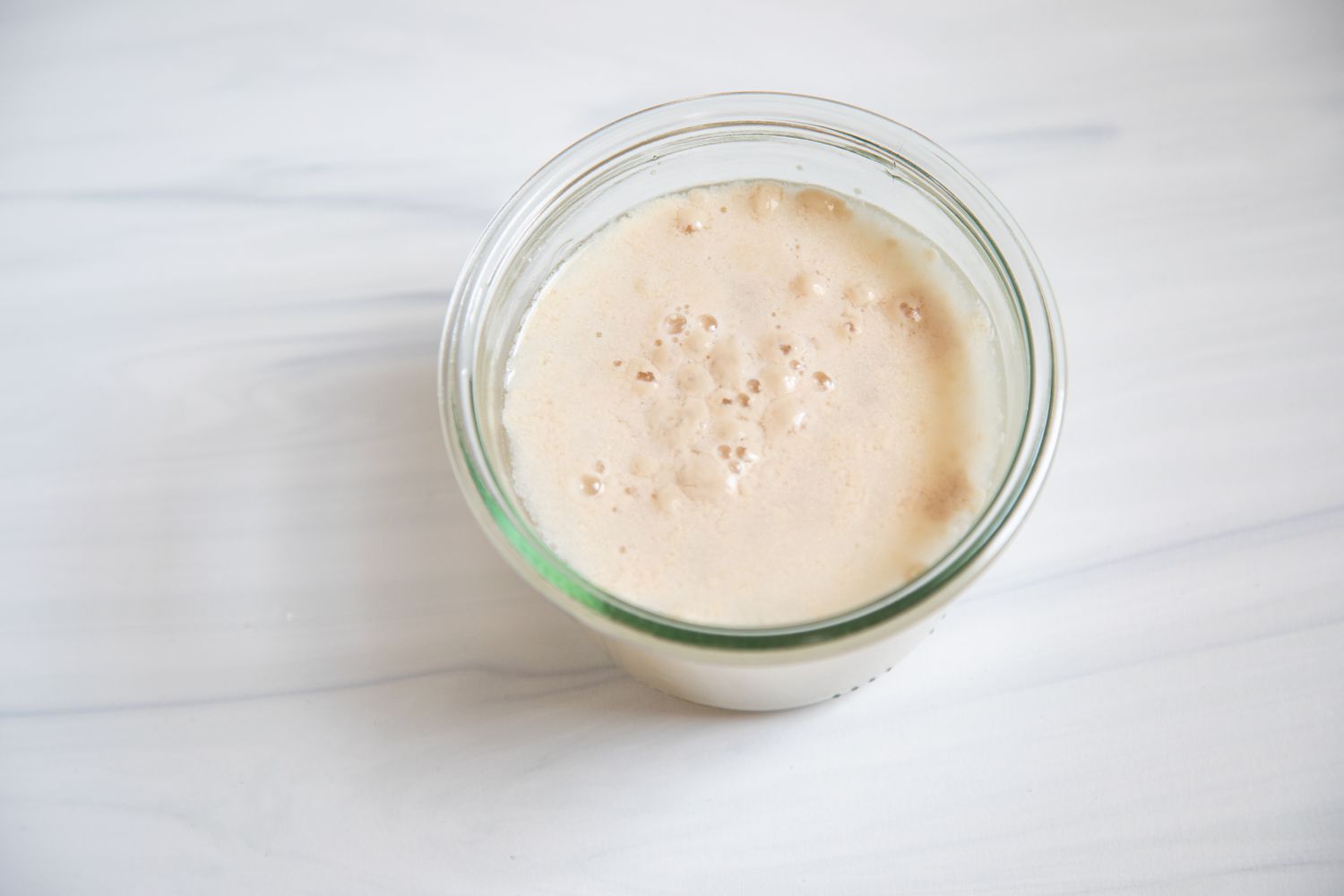 A frothy cup of proofed yeast.