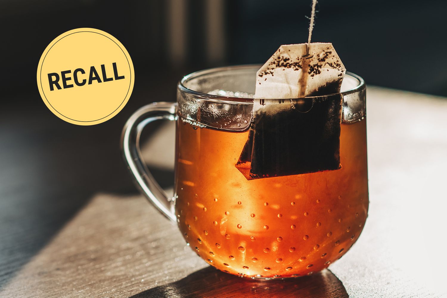 A clear glass mug with a teabag steeping in it
