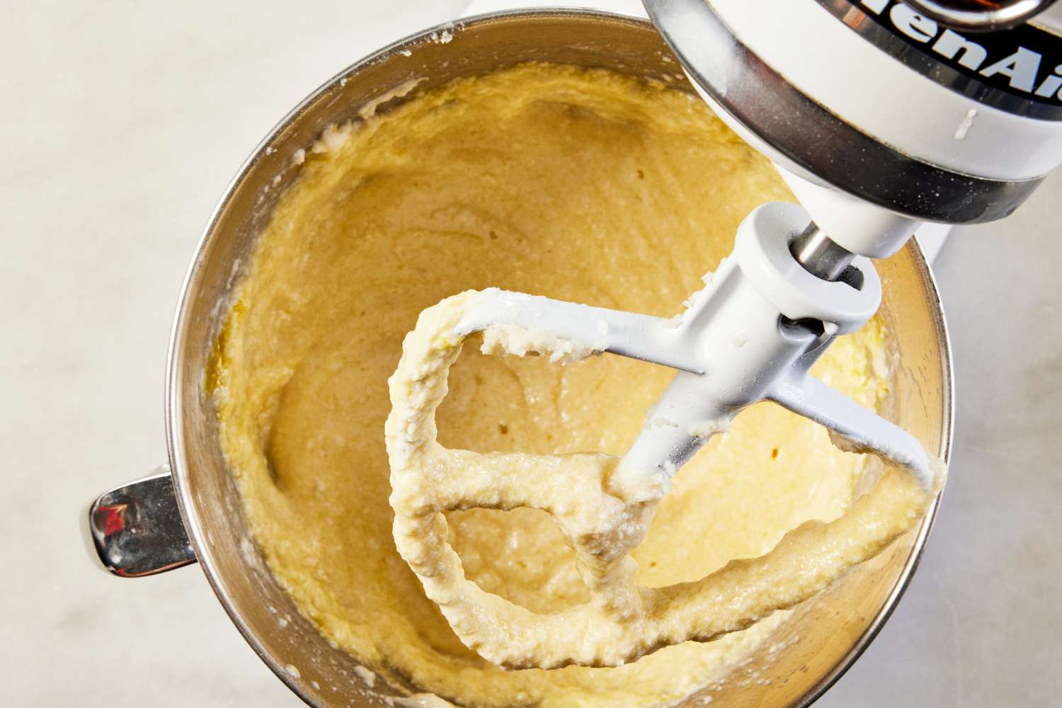 wet ingredients mixed into butter-flour mixture in stand mixer for pink lemonade cake recipe