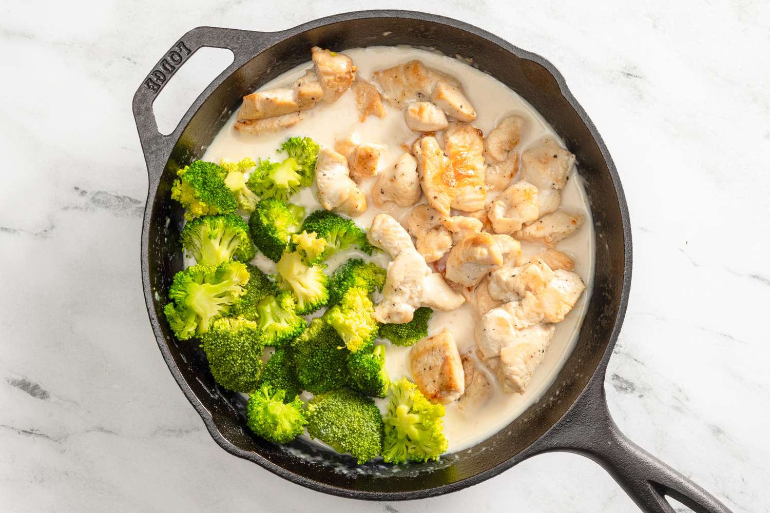 Chicken and broccoli added back to the skillet with the sauce for chicken divan recipe