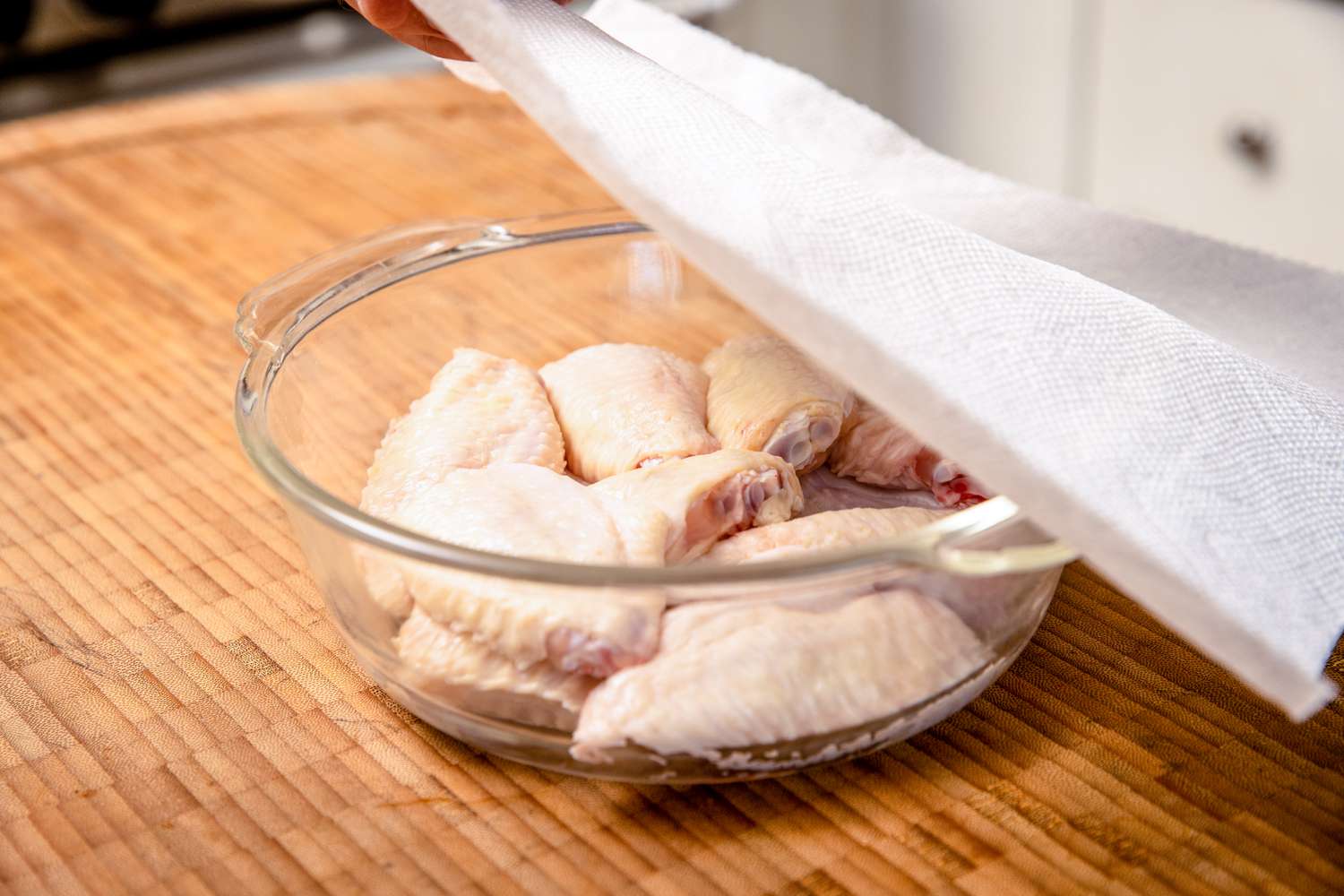 Microwave Safe Bowl with Chicken Flats Covered with a Paper Towel for Microwave Wings Recipe