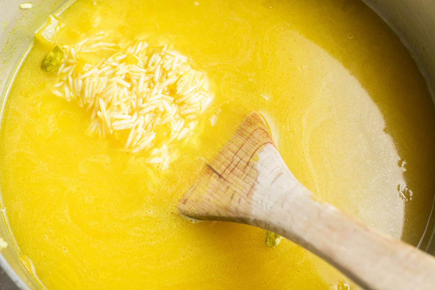 Basmati Rice and Water Added to the Pot With the SautÃ©ed Onions for Halal Cart-Style Chicken and Rice Recipe