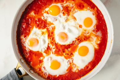 Skillet with eggs cooked in a tomatobased sauce a dish known as eggs in purgatory