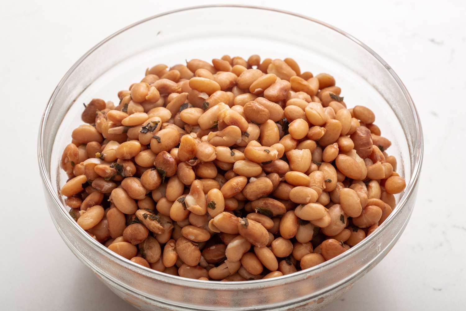 Cooked beans resting in a glass bowl 