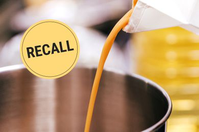 Liquid eggs being poured from a carton into a saucepan with a "Recall" badge superimposed on the image