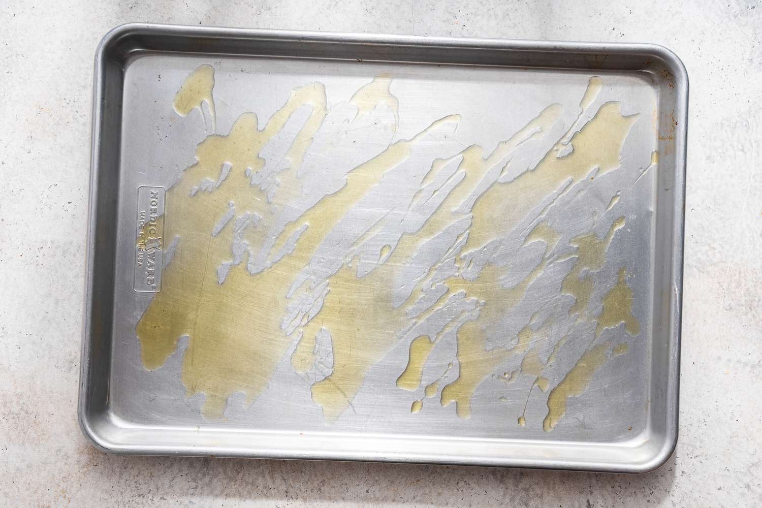 Baking pan drizzled with olive oil for crash hot potatoes recipe