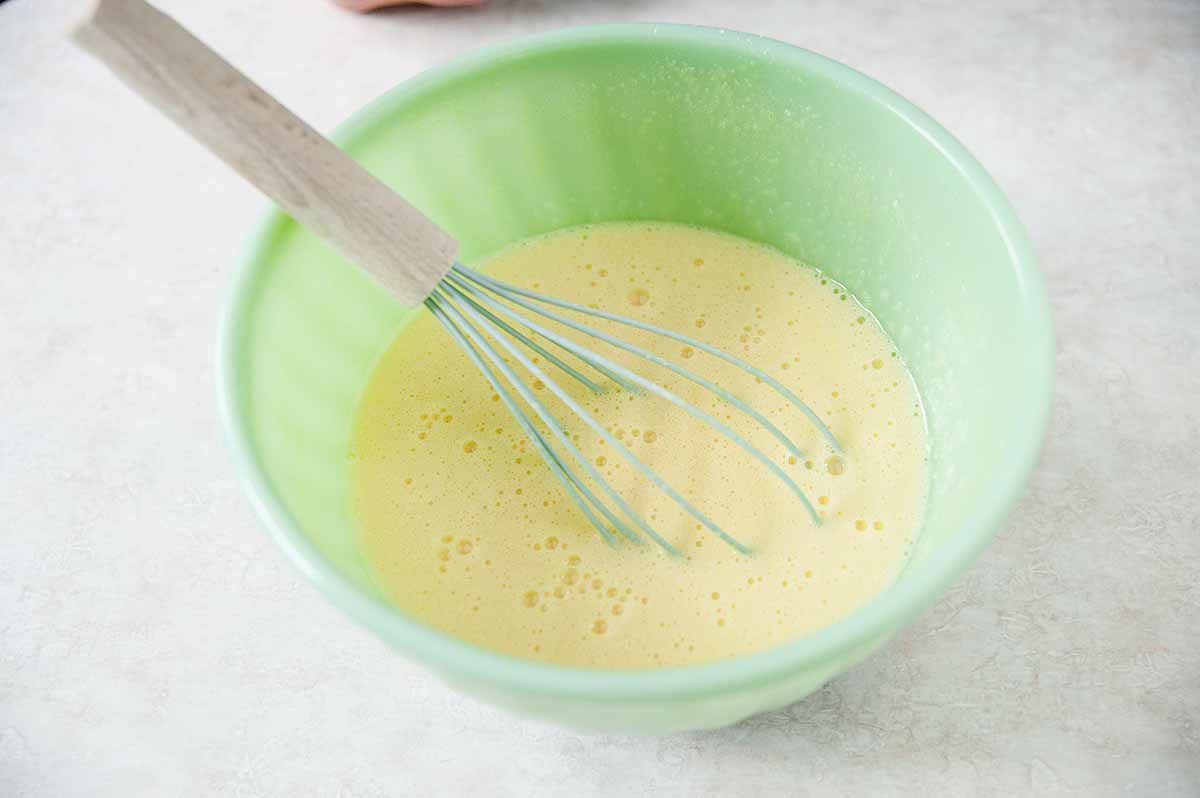 Lemon Bars Recipe - bowl of lemon curd with whisk