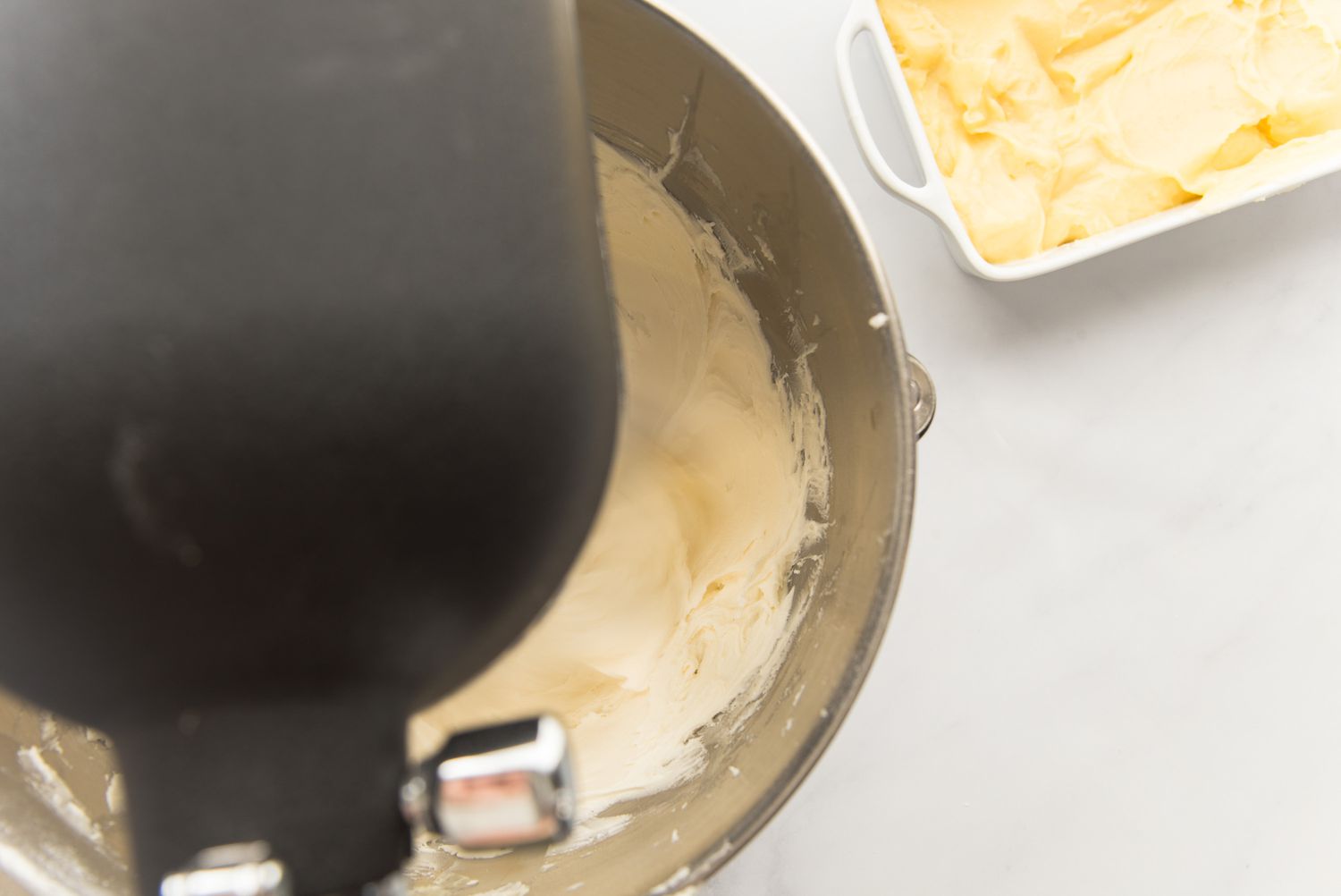 Whipping a German buttercream recipe in a stand mixer.