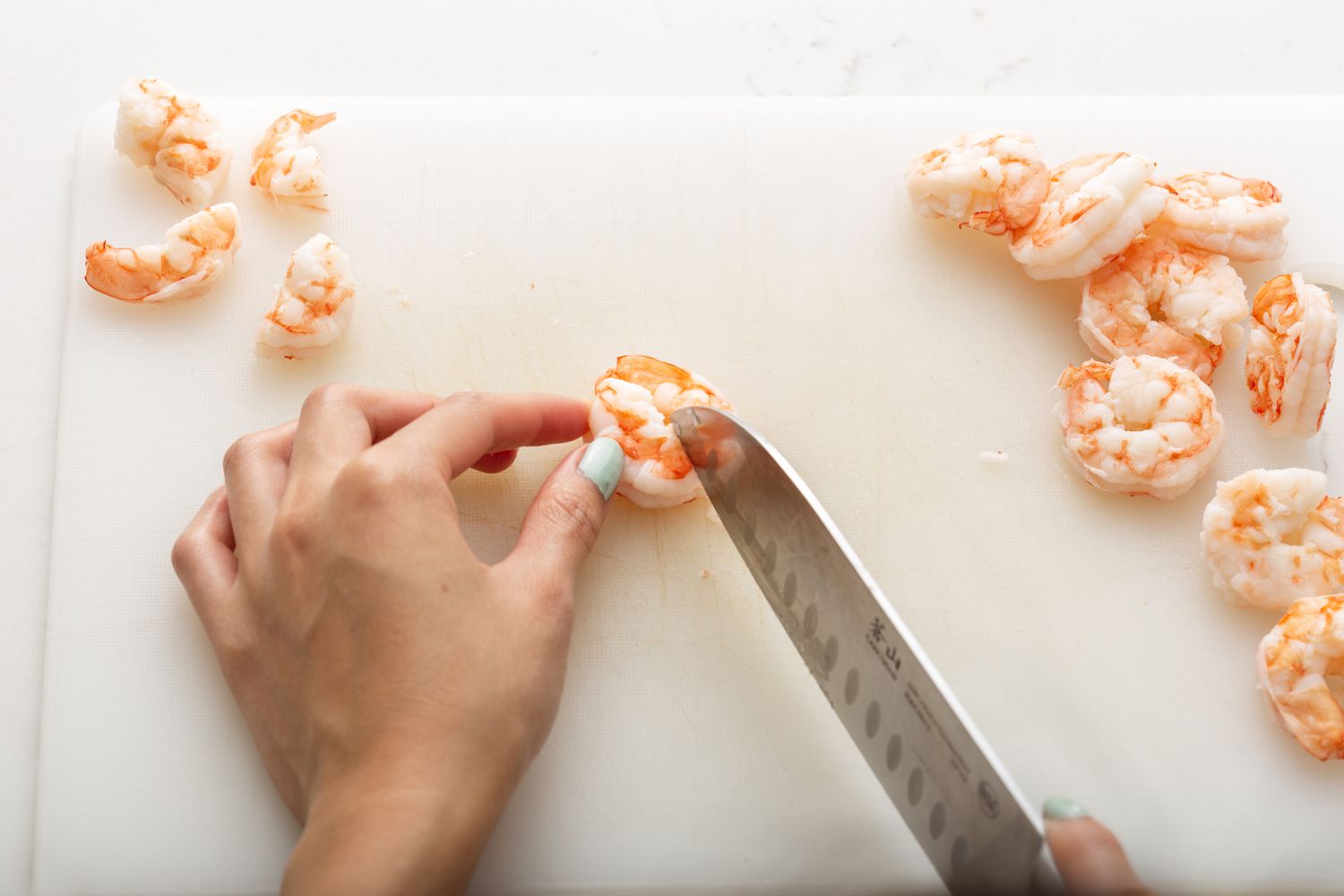 Slicing shrimp for a shrimp ceviche recipe.