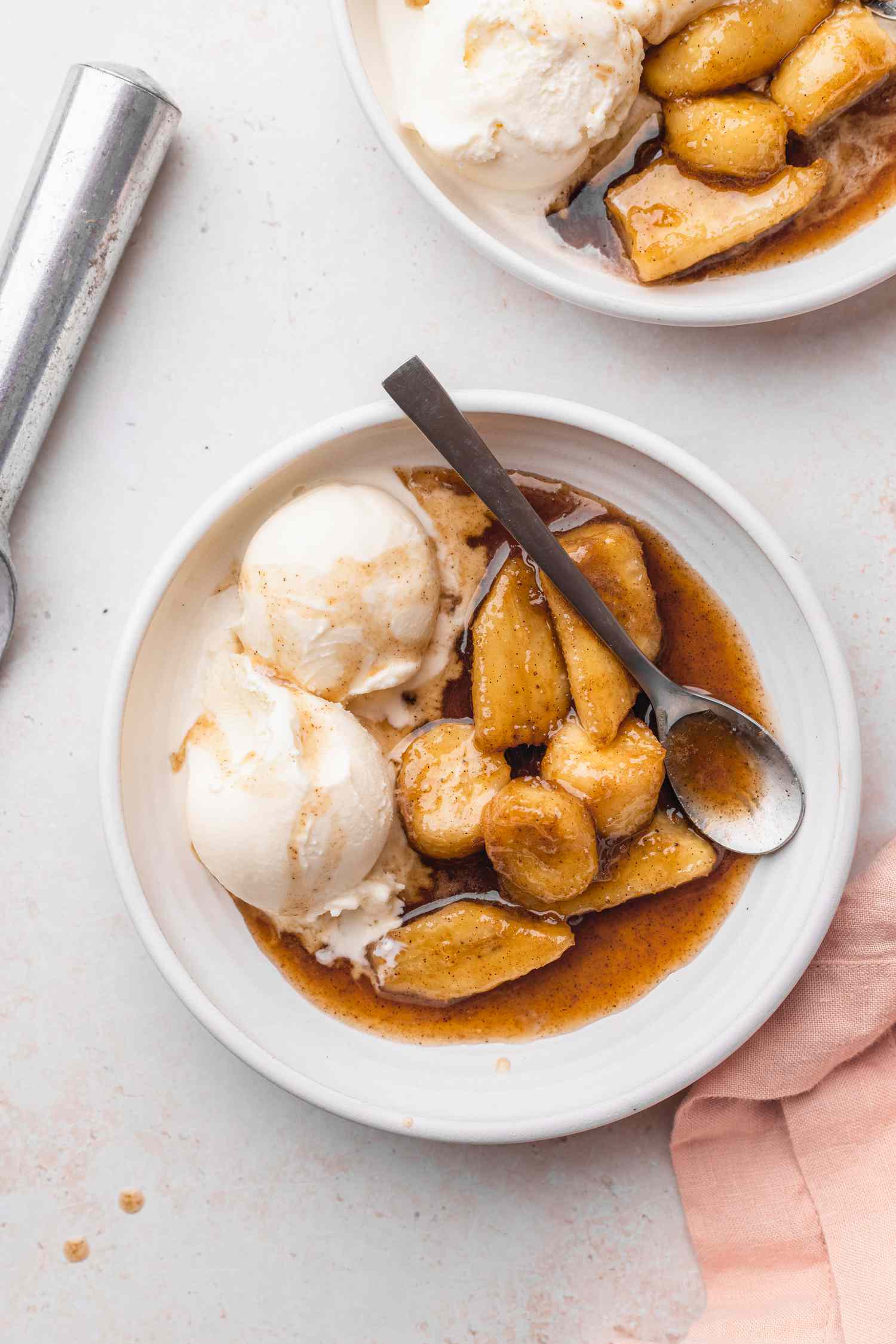 Plates of Bananas Foster with Scoops of Vanilla Ice Cream