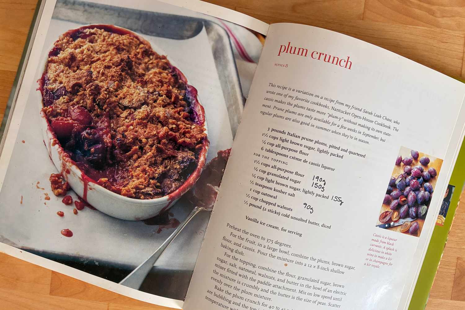 Cookbook open to a plum crunch recipe with an image of the dish