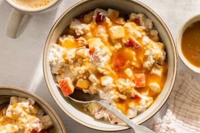 A bowl of overnight oats topped with diced apple and caramel drizzle
