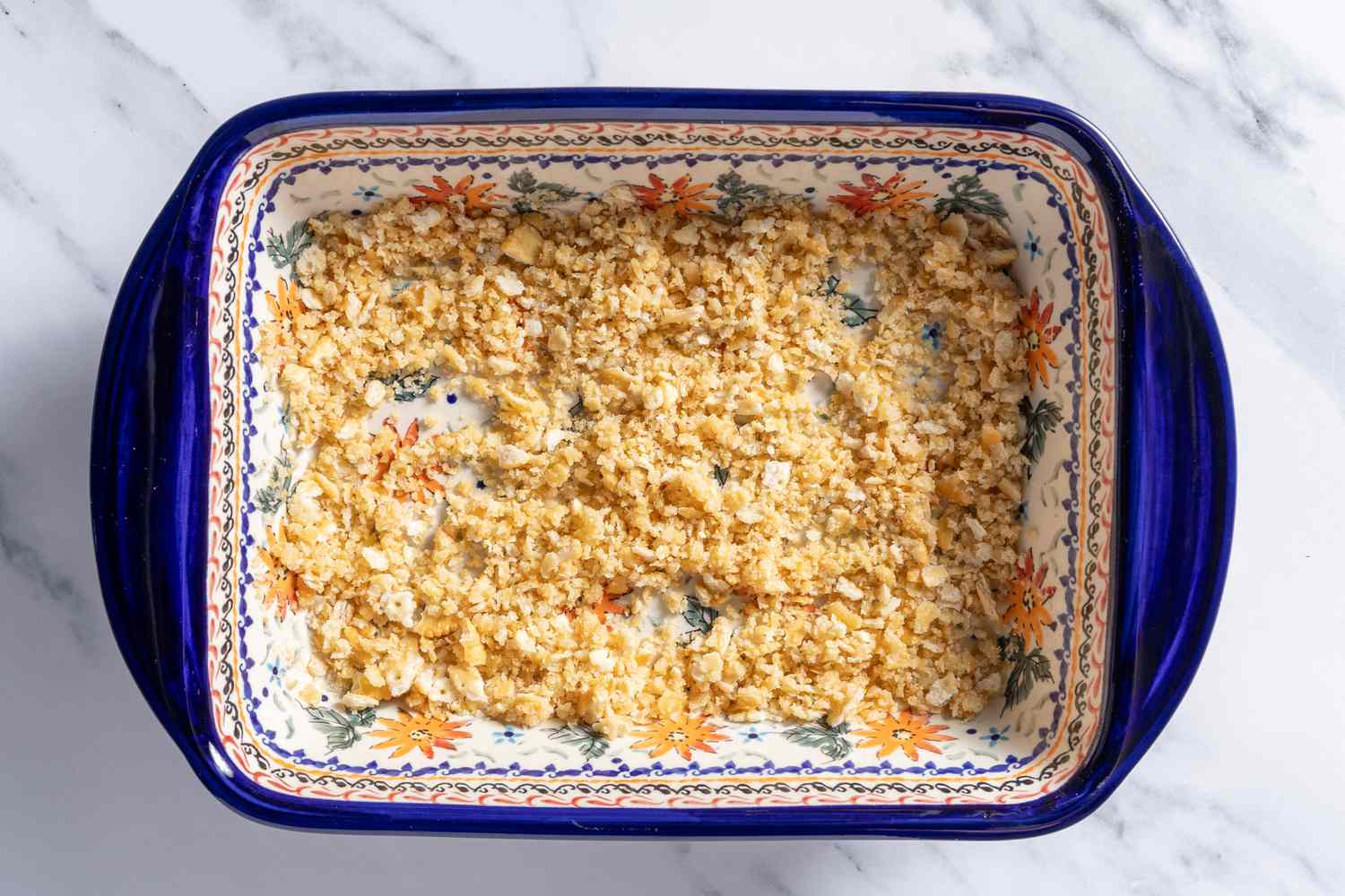 breadcrumbs tossed in butter in casserol dish for southern squash casserole recipe