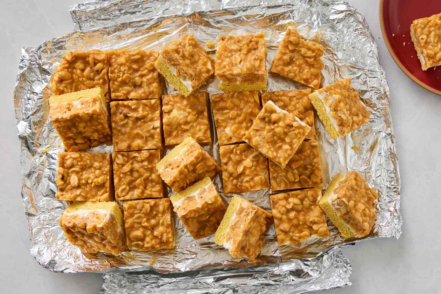 Salted nut bars cut into squares on foil ready to serve